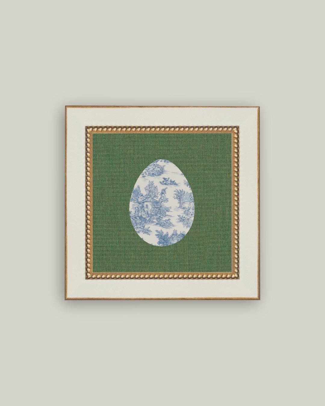 Framed artwork with a green background and blue floral design on a gray background