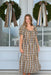 Women's plaid midi dress featuring a square neckline with adjustable tie, puff sleeves, empire waist, tiered skirt, and a woven brown, cream, and dusty blue plaid pattern.