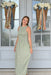 Sage green gingham maxi dress with a smocked bodice, sleeveless design, high neckline, and flowing gathered skirt
