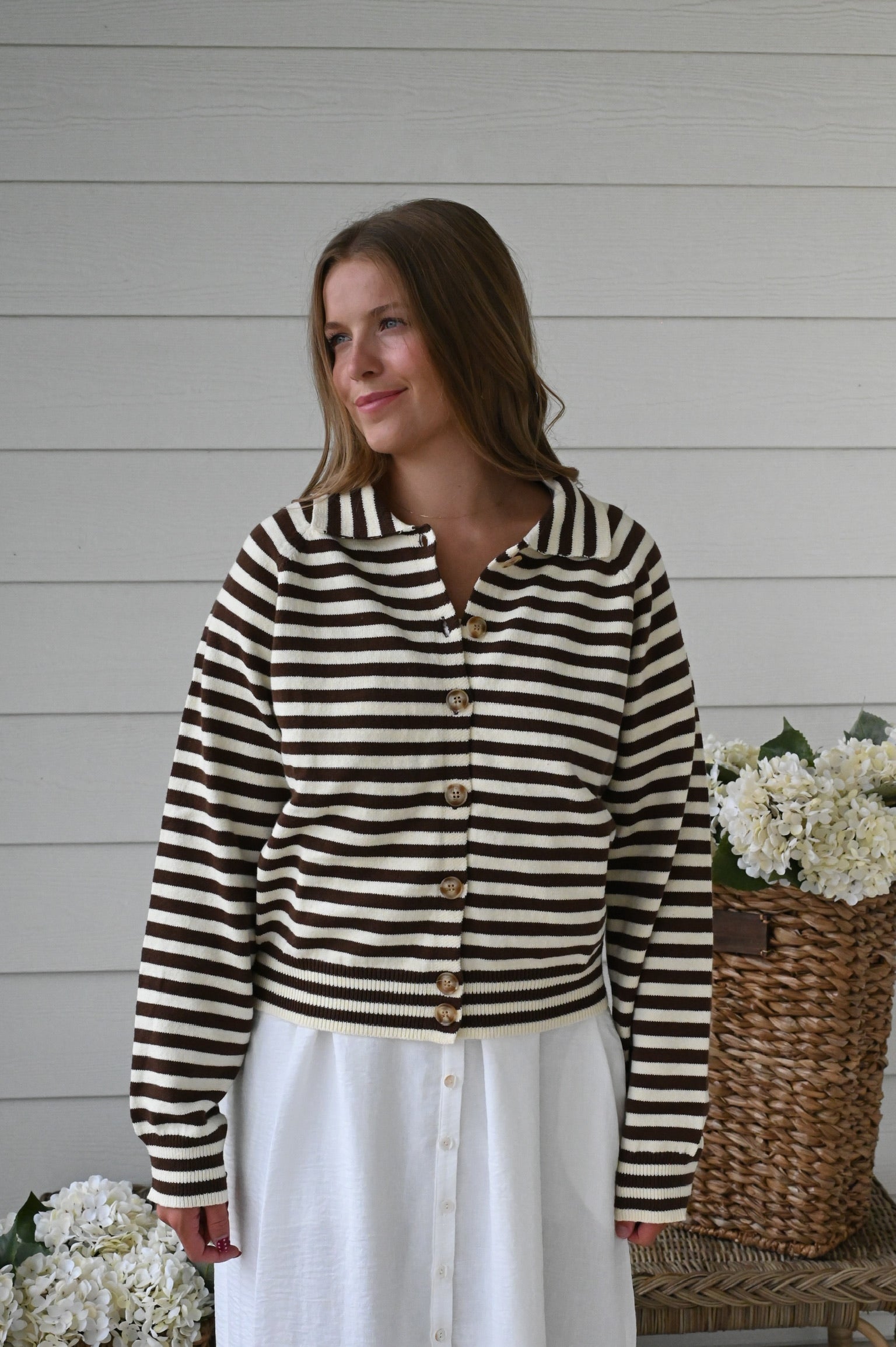 Brown and ivory striped knit cardigan with a collared neckline, button-front closure, long sleeves, and ribbed cuffs and hem.