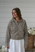 Brown and ivory striped knit cardigan with a collared neckline, button-front closure, long sleeves, and ribbed cuffs and hem.