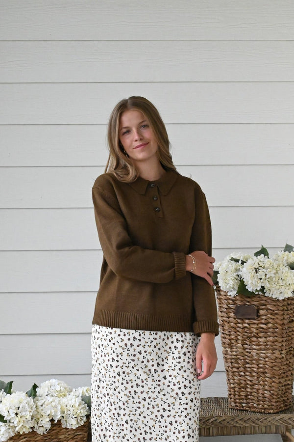 Chocolate brown knit pullover sweater with a classic crew neckline, ribbed cuffs and hem, and a relaxed fit.