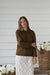 Chocolate brown knit pullover sweater with a classic crew neckline, ribbed cuffs and hem, and a relaxed fit.